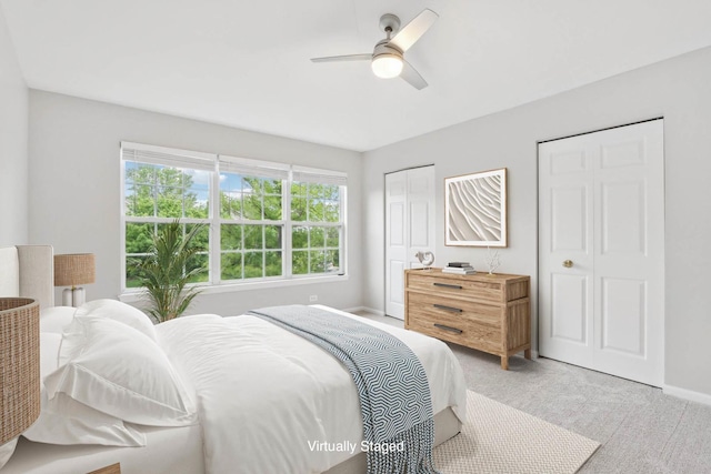 2913 Glenarye Dr, Lindenhurst, IL 60046 - bedroom with two closets, light carpet, baseboards, and a ceiling fan