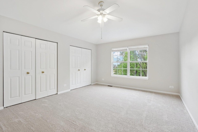 2913 Glenarye Dr, Lindenhurst, IL 60046 - unfurnished bedroom with two closets, baseboards, carpet, and a ceiling fan