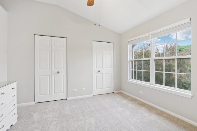 2913 Glenarye Dr, Lindenhurst, IL 60046 - unfurnished bedroom with two closets, vaulted ceiling, light carpet, and multiple windows