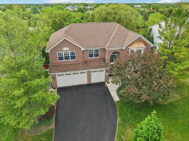 2913 Glenarye Dr, Lindenhurst, IL 60046 - view of front of house with asphalt driveway, a garage, brick siding, and a view of trees