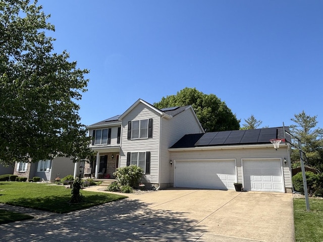 2610 Worthington Dr, Champaign, IL 61822 - traditional home with a garage, concrete driveway, roof mounted solar panels, and a front lawn