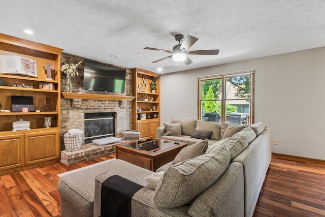 2610 Worthington Dr, Champaign, IL 61822 - living area with ceiling fan, hardwood / wood-style flooring, a textured ceiling, a fireplace, and baseboards