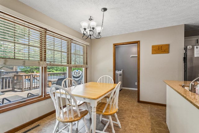2610 Worthington Dr, Champaign, IL 61822 - tiled dining room with a chandelier, baseboards, and a textured ceiling