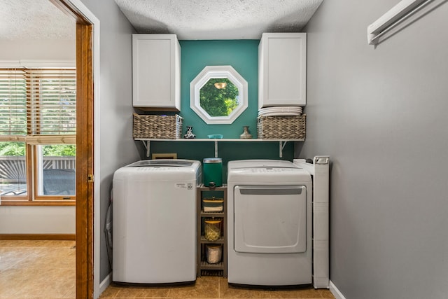 2610 Worthington Dr, Champaign, IL 61822 - laundry area with cabinet space, independent washer and dryer, a textured ceiling, baseboards, and light tile patterned floors