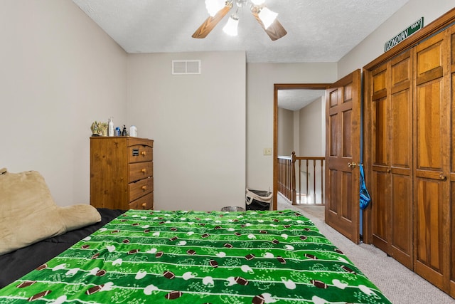 2610 Worthington Dr, Champaign, IL 61822 - bedroom with carpet flooring, a textured ceiling, and a ceiling fan