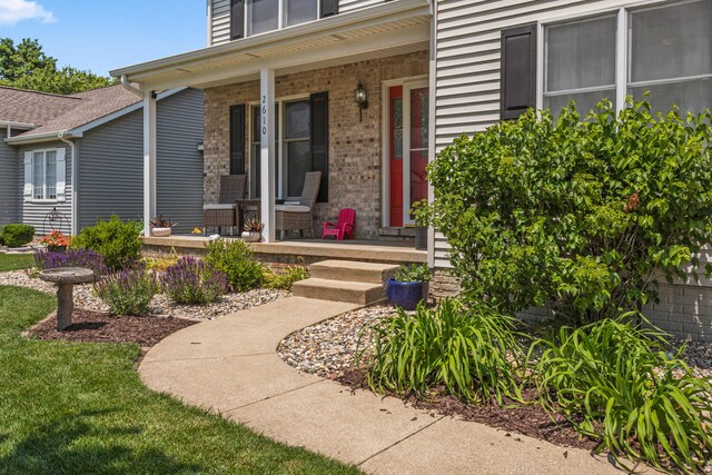 2610 Worthington Dr, Champaign, IL 61822 - view of exterior entry featuring covered porch and brick siding