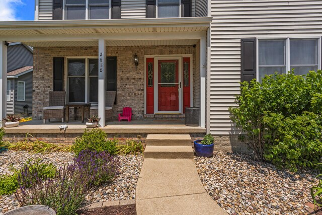 2610 Worthington Dr, Champaign, IL 61822 - property entrance featuring covered porch and brick siding