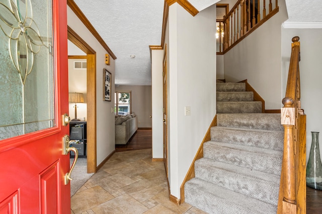 2610 Worthington Dr, Champaign, IL 61822 - foyer with baseboards, stairs, light stone finish flooring, a textured ceiling, and crown molding
