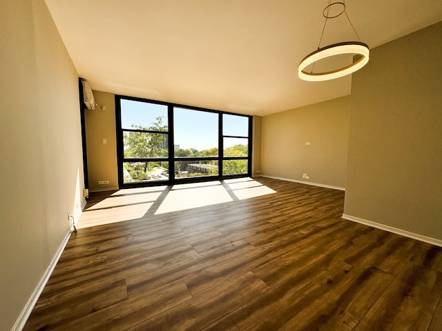 2605 S Indiana Ave Unit 501, Chicago, IL 60616 - spare room with expansive windows, dark wood-type flooring, and baseboards