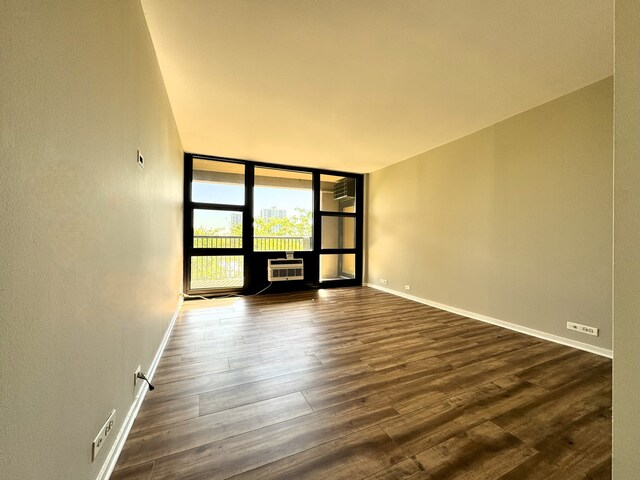 2605 S Indiana Ave Unit 501, Chicago, IL 60616 - empty room with a wall of windows, dark wood finished floors, and baseboards