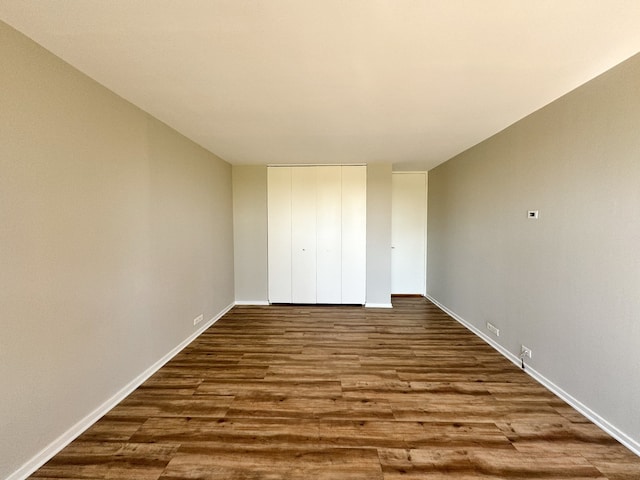 2605 S Indiana Ave Unit 501, Chicago, IL 60616 - unfurnished bedroom featuring dark wood-style flooring, baseboards, and a closet