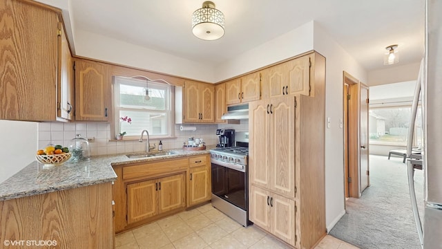 3434 Monroe St, Lansing, IL 60438 - kitchen featuring gas range, a sink, under cabinet range hood, light stone countertops, and decorative backsplash