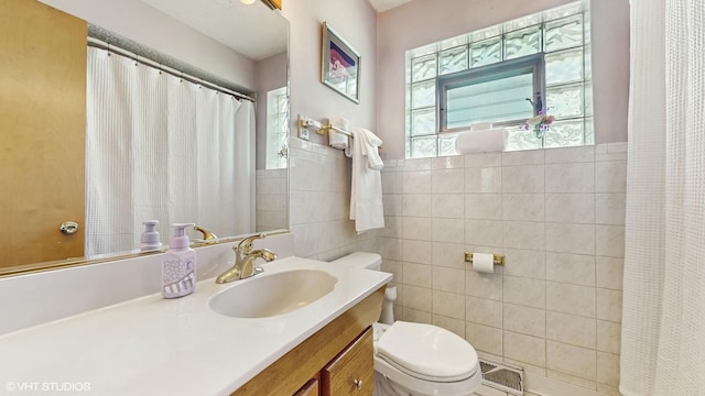 3434 Monroe St, Lansing, IL 60438 - full bath with healthy amount of natural light, tile walls, toilet, vanity, and a shower with shower curtain