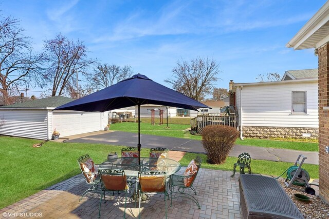 3434 Monroe St, Lansing, IL 60438 - view of patio featuring an outbuilding, outdoor dining space, and a garage