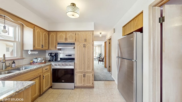 3434 Monroe St, Lansing, IL 60438 - kitchen featuring appliances with stainless steel finishes, under cabinet range hood, a sink, light stone countertops, and decorative backsplash