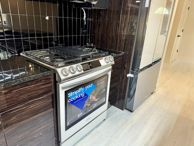 13235 S Vernon Ave, Chicago, IL 60827 - kitchen with gas range, freestanding refrigerator, and dark brown cabinetry