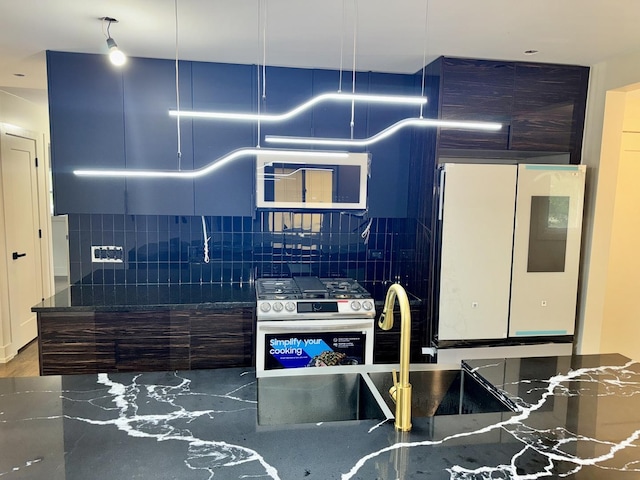 13235 S Vernon Ave, Chicago, IL 60827 - kitchen featuring fridge, tasteful backsplash, stainless steel range with gas stovetop, and dark stone counters