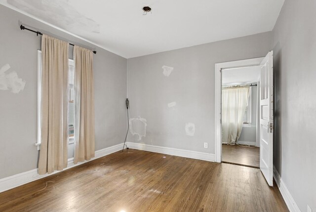 3731 Maple Ave, Berwyn, IL 60402 - unfurnished room featuring wood finished floors and baseboards