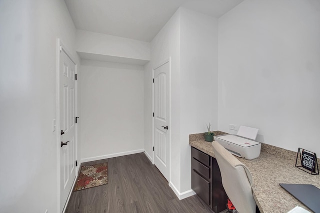 office with dark wood-style floors and baseboards