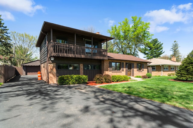 16W340 94th Pl, Burr Ridge, IL 60527 - view of front of property with brick siding, a balcony, a detached garage, an outbuilding, and a front lawn