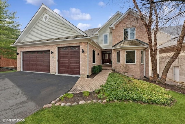 21827 W Riviera Ct, Ivanhoe, IL 60060 - traditional-style home featuring driveway, a garage, and brick siding