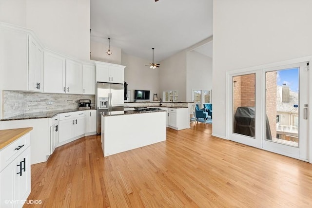 21827 W Riviera Ct, Ivanhoe, IL 60060 - kitchen featuring a ceiling fan, high vaulted ceiling, stainless steel built in fridge, decorative backsplash, and a kitchen island