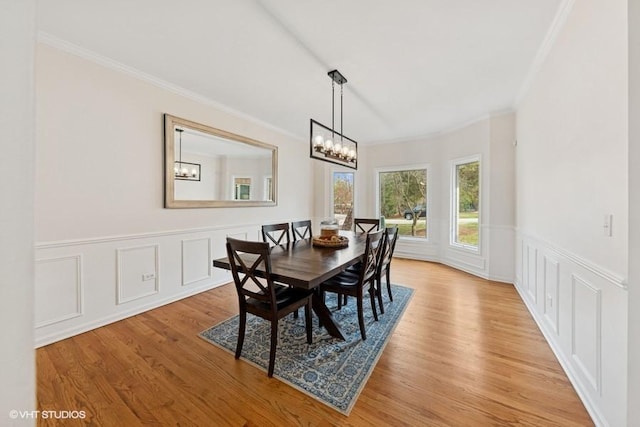 21827 W Riviera Ct, Ivanhoe, IL 60060 - dining area featuring crown molding, light wood-type flooring, a chandelier, a wainscoted wall, and a decorative wall