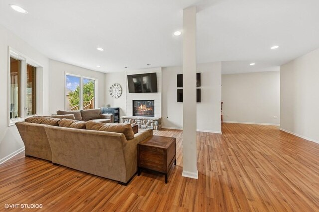 21827 W Riviera Ct, Ivanhoe, IL 60060 - living area with light wood-style floors, a fireplace, recessed lighting, and baseboards