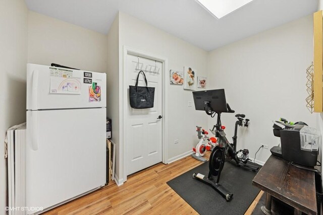 21827 W Riviera Ct, Ivanhoe, IL 60060 - exercise area featuring light wood finished floors, radiator heating unit, and baseboards