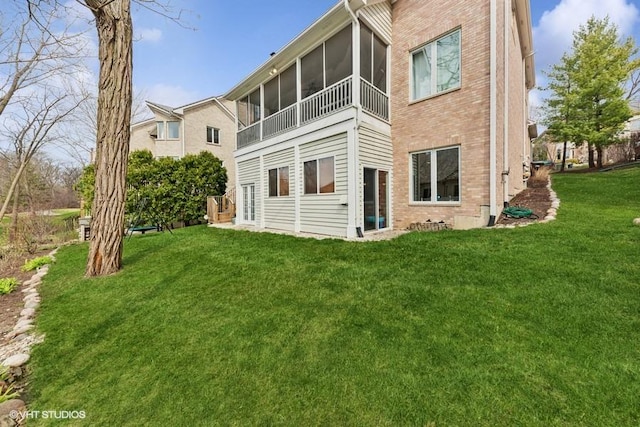 21827 W Riviera Ct, Ivanhoe, IL 60060 - back of property with brick siding, a lawn, and a sunroom