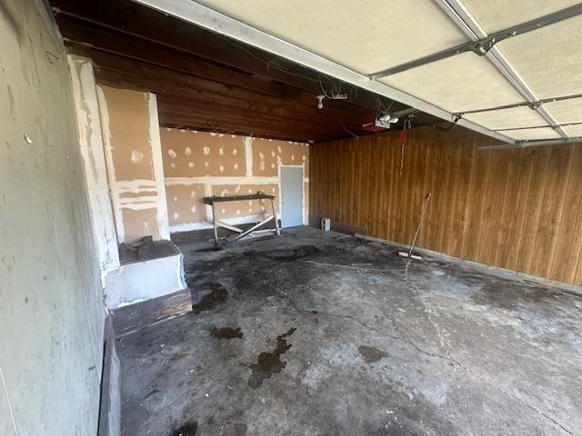 112 Minton St, Joliet, IL 60436 - garage featuring wooden walls and a garage door opener