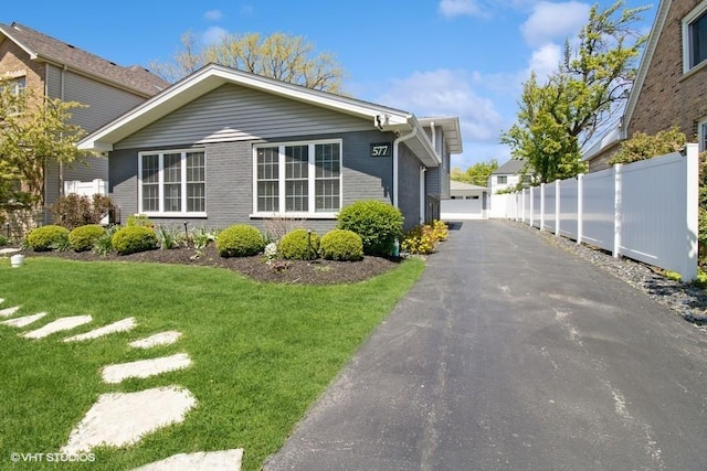 view of side of home with brick siding and a detached garage