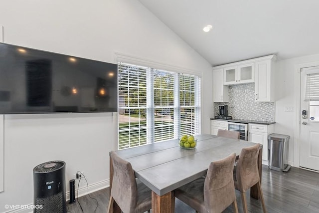 dining space with wine cooler, dark wood-style floors, vaulted ceiling, recessed lighting, and baseboards