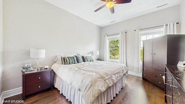 bedroom featuring baseboards, dark wood finished floors, lofted ceiling, and a ceiling fan