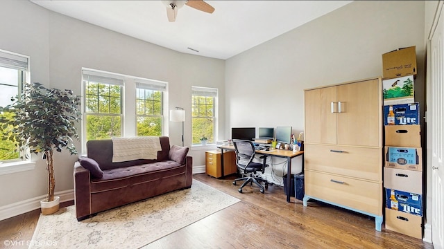 office area featuring wood finished floors, ceiling fan, and baseboards