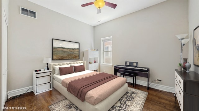 bedroom with dark wood-type flooring, baseboards, and a ceiling fan