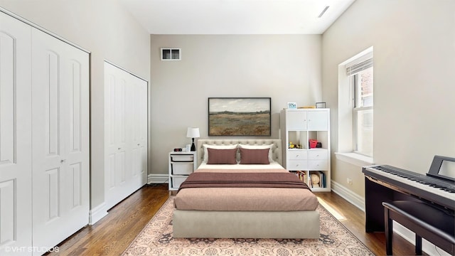 bedroom featuring wood finished floors and baseboards