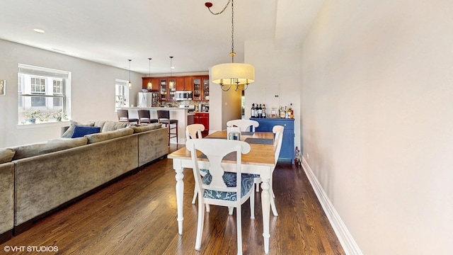 dining space featuring dark wood-style floors, baseboards, a chandelier, and recessed lighting