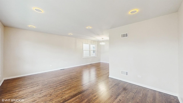 3524 N Natoma Ave, Chicago, IL 60634 - empty room featuring wood finished floors, baseboards, and a chandelier