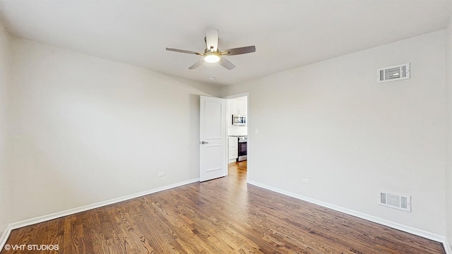 3524 N Natoma Ave, Chicago, IL 60634 - spare room with baseboards, wood finished floors, and a ceiling fan