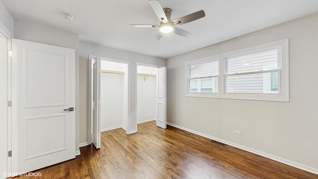 3524 N Natoma Ave, Chicago, IL 60634 - unfurnished bedroom with two closets, baseboards, wood finished floors, and ceiling fan