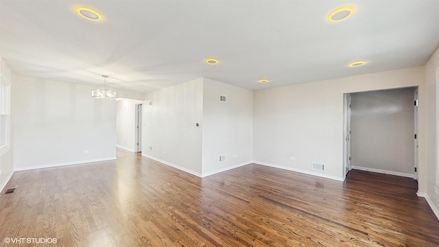 3524 N Natoma Ave, Chicago, IL 60634 - spare room with a chandelier, wood finished floors, and baseboards