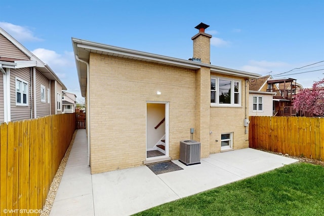 3524 N Natoma Ave, Chicago, IL 60634 - back of house featuring fence, a patio, brick siding, and a chimney