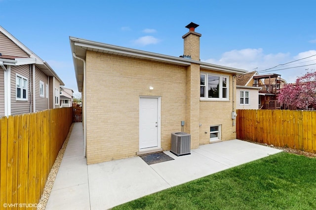 3524 N Natoma Ave, Chicago, IL 60634 - back of property with a patio, central AC unit, a chimney, and brick siding