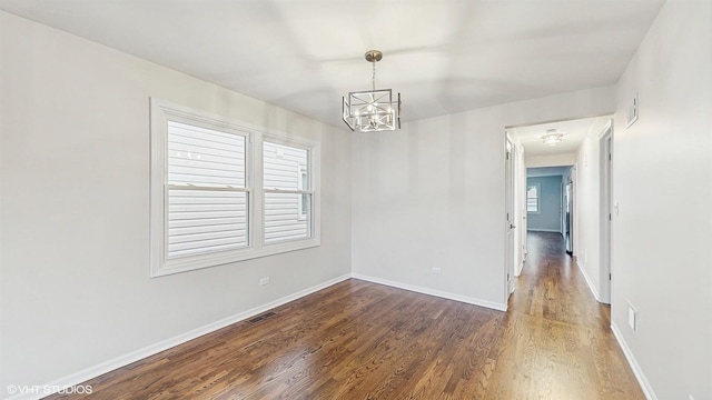 3524 N Natoma Ave, Chicago, IL 60634 - empty room featuring a chandelier, wood finished floors, and baseboards