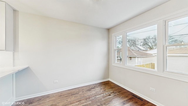 3524 N Natoma Ave, Chicago, IL 60634 - unfurnished dining area with wood finished floors and baseboards