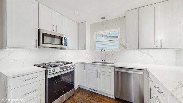 3524 N Natoma Ave, Chicago, IL 60634 - kitchen with appliances with stainless steel finishes, a sink, decorative backsplash, light stone countertops, and white cabinets