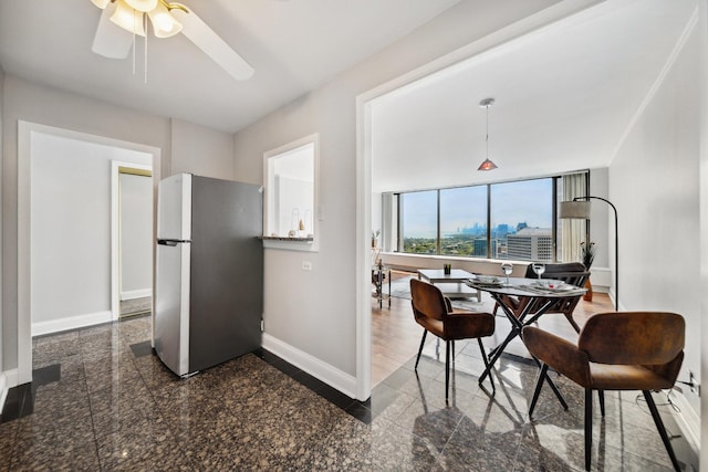 5455 N Sheridan Rd Unit 3804, Chicago, IL 60640 - kitchen featuring freestanding refrigerator, granite floors, baseboards, and a ceiling fan