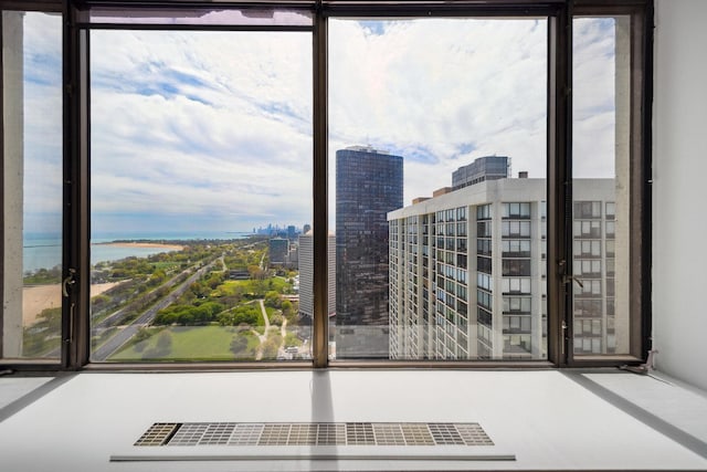 doorway featuring healthy amount of natural light, a view of city, and a water view