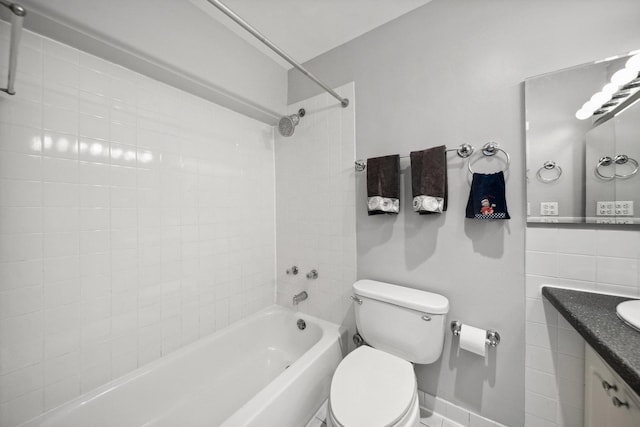 full bath with toilet, vanity, shower / bath combination, and baseboards